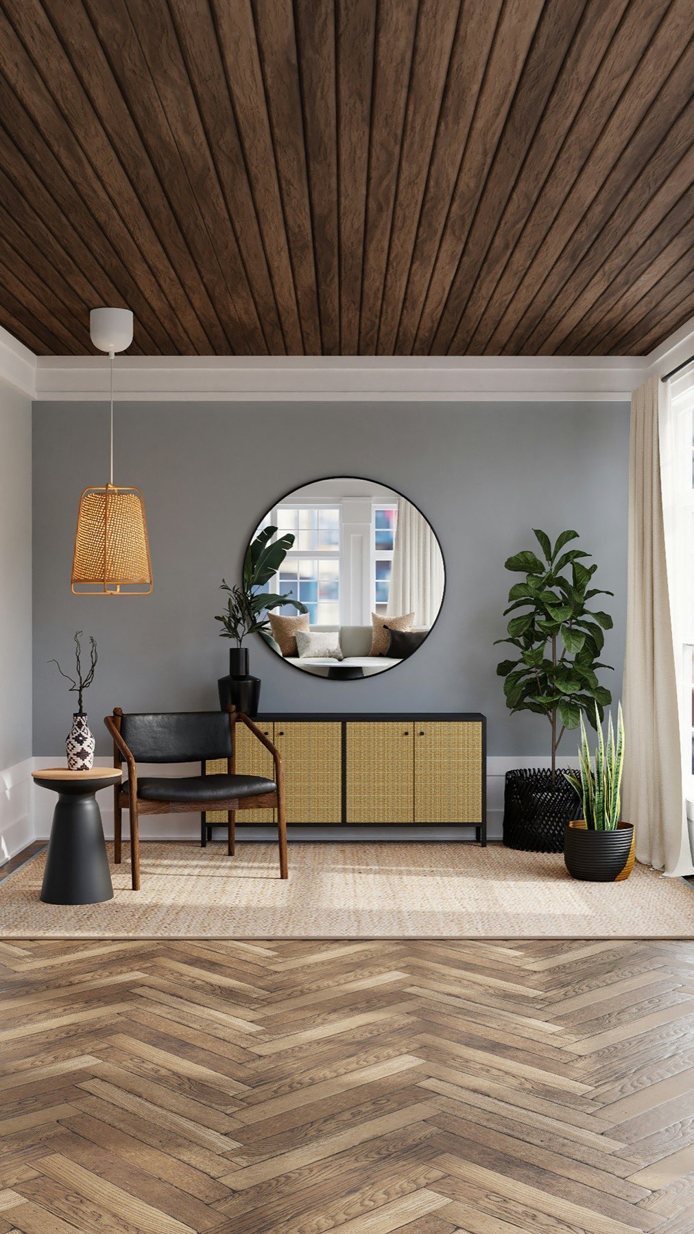 Muted grey room with a caned sideboard, round mirror and woven pendant