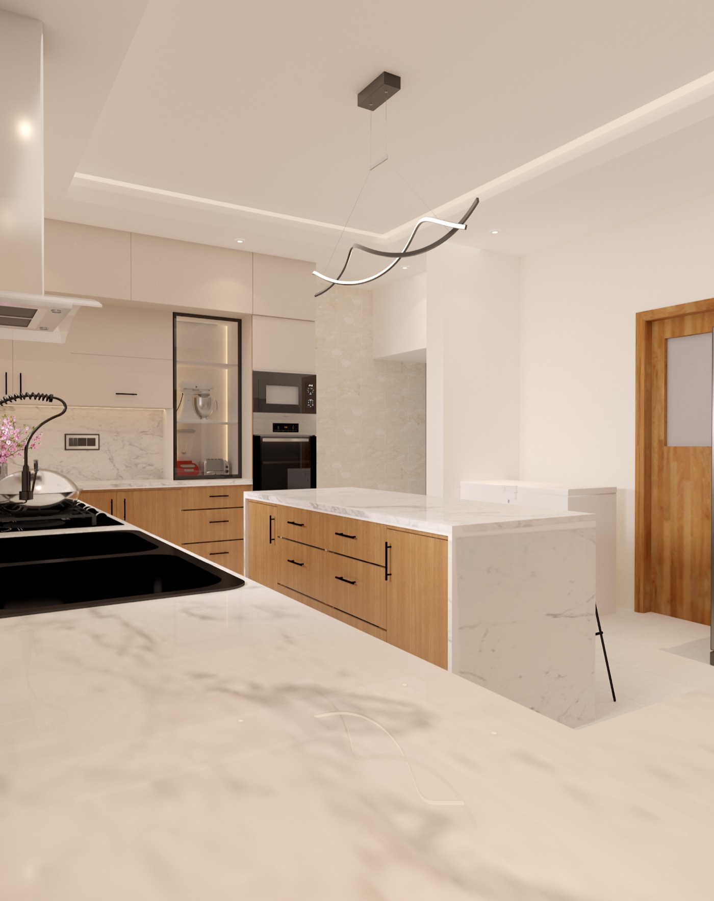 Galley view to the built-in ovens, dark worktop against warm timber fronts