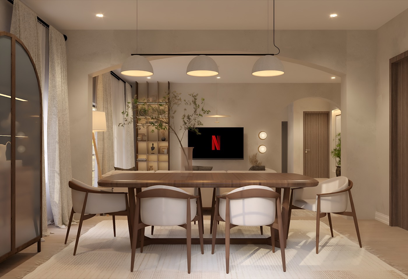 Dining table with rattan-backed chairs under a run of pendants