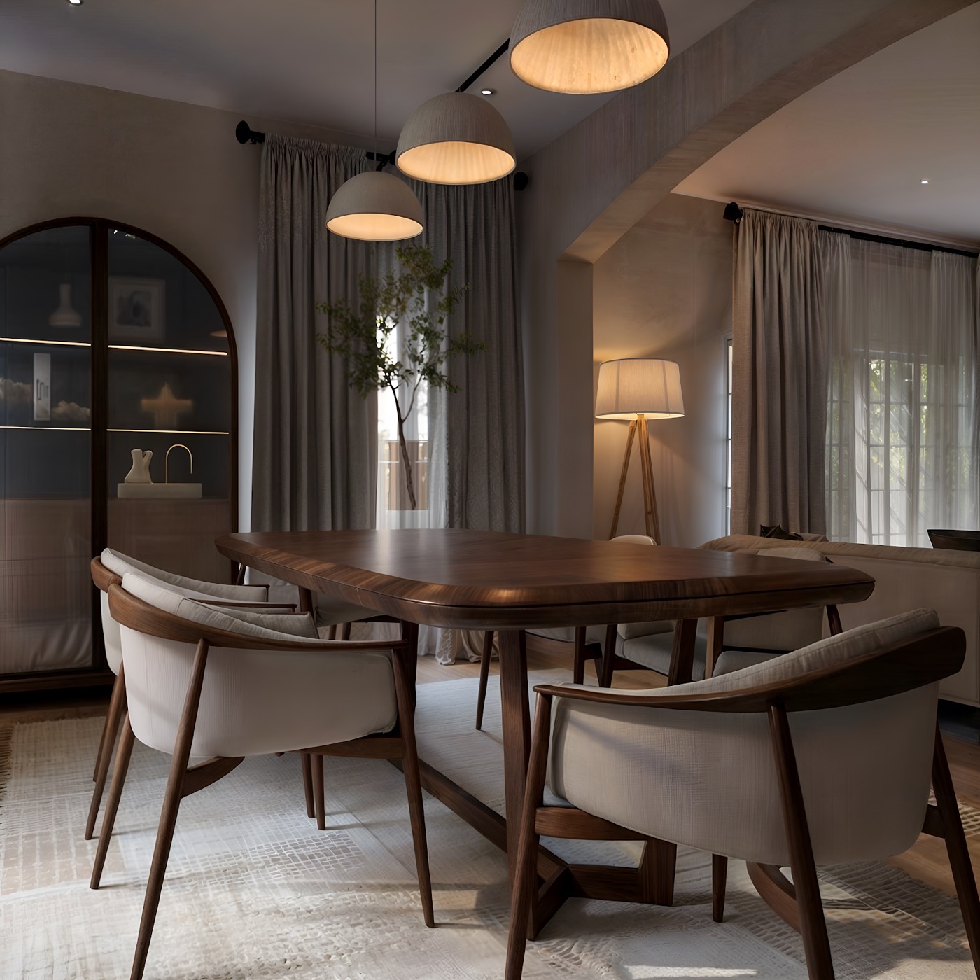 Round dining table and upholstered chairs beneath a domed ceiling light