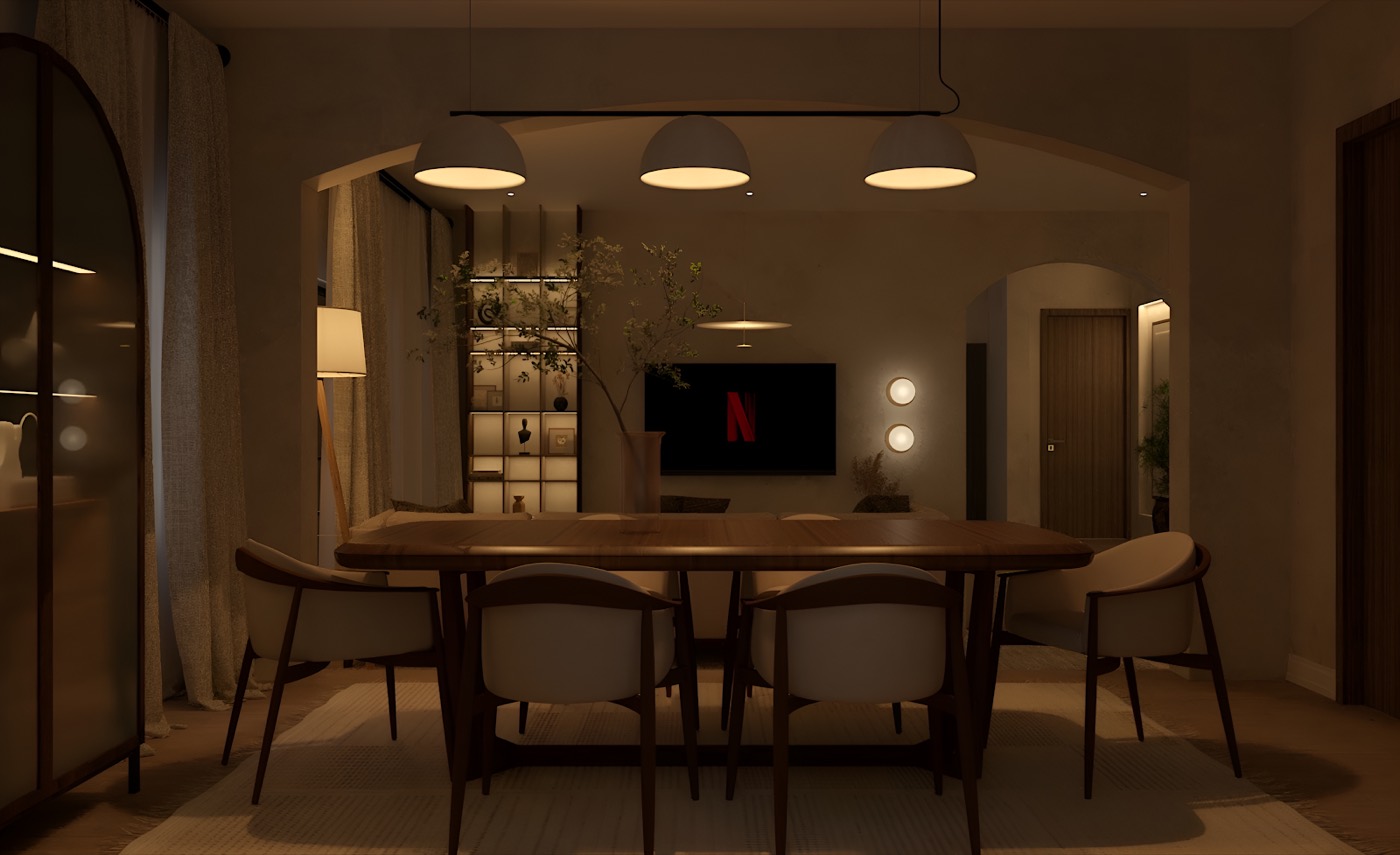 The dining room after dark, warm cove lighting along the ceiling