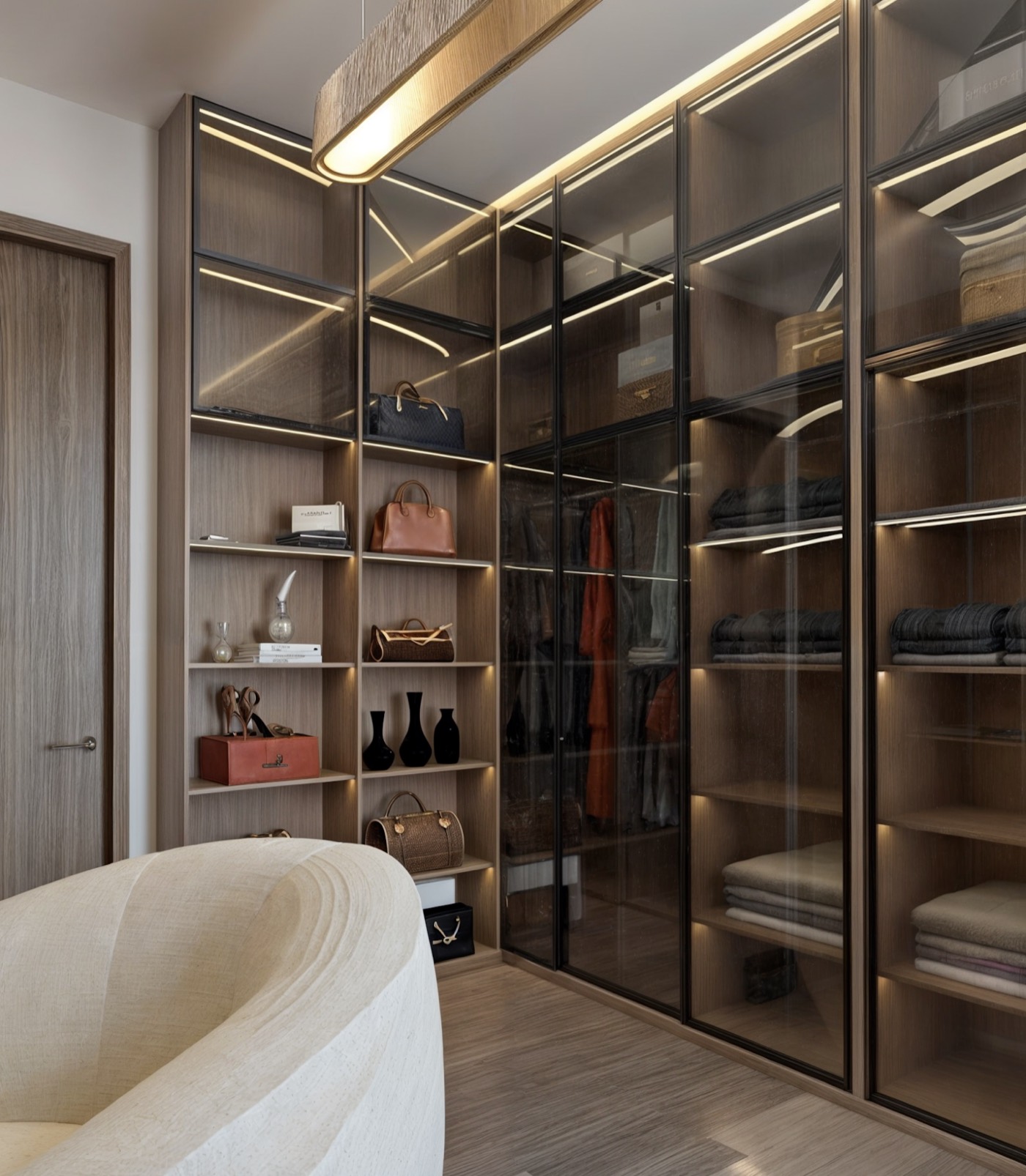 Full-height glazed wardrobe run, lit from inside