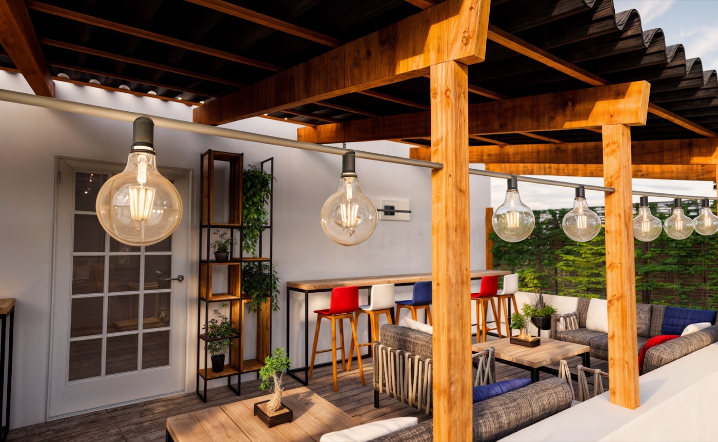 Timber pergola strung with festoon bulbs over lounge seating