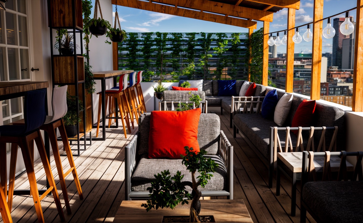 Terrace with planting and bar stools, the skyline beyond